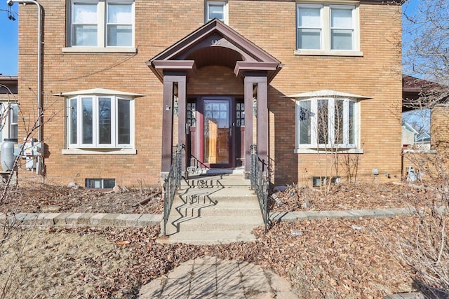 property entrance featuring brick siding