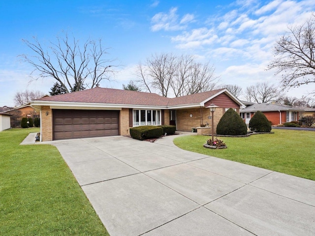 ranch-style house featuring a garage and a front lawn