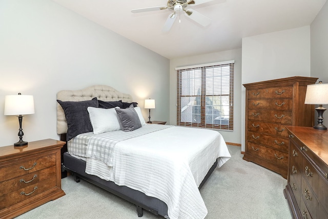 bedroom with light carpet, vaulted ceiling, and ceiling fan