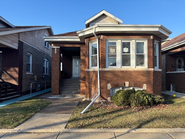 bungalow-style home with brick siding