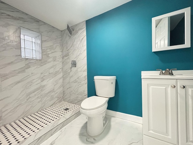 bathroom featuring a stall shower, baseboards, toilet, marble finish floor, and vanity