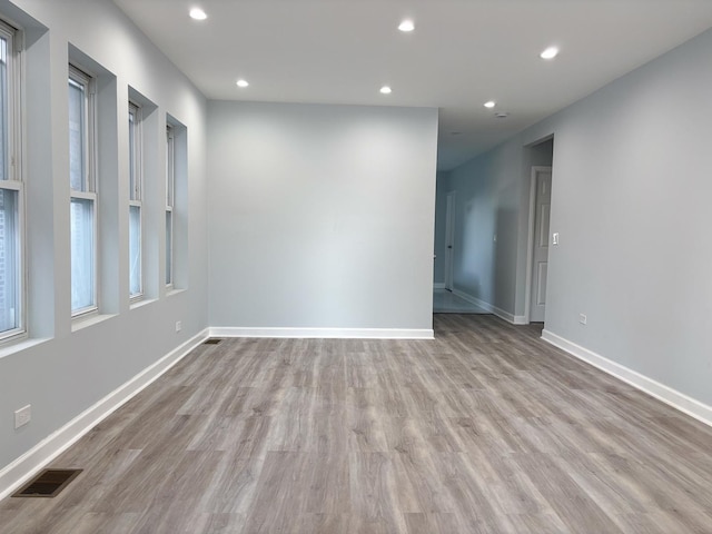 spare room with light wood-style floors, baseboards, visible vents, and recessed lighting