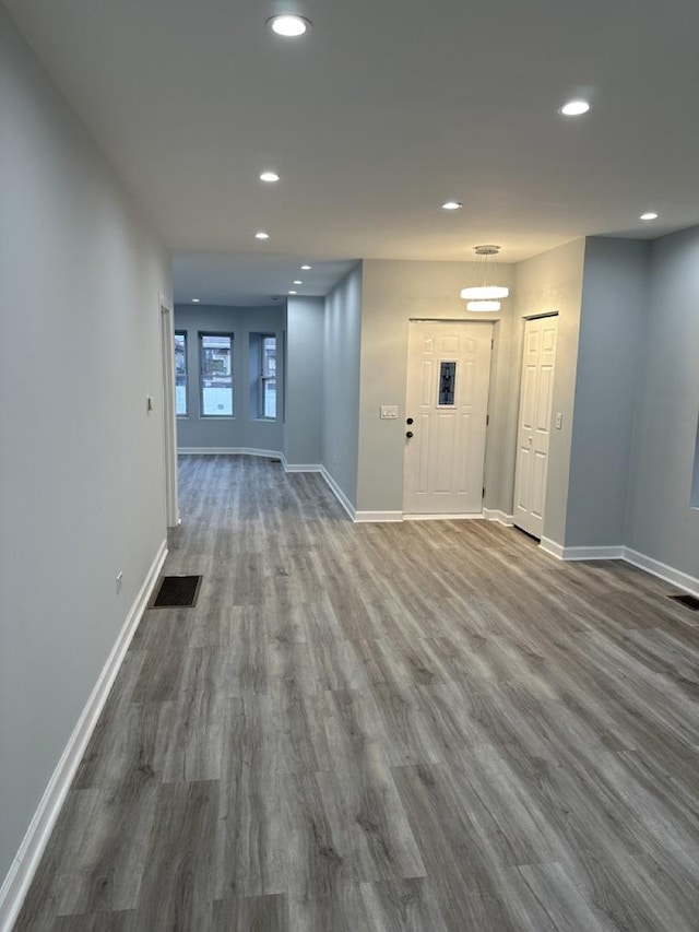 interior space with baseboards, dark wood finished floors, and recessed lighting