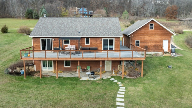 back of house with a wooden deck, a patio area, and a lawn