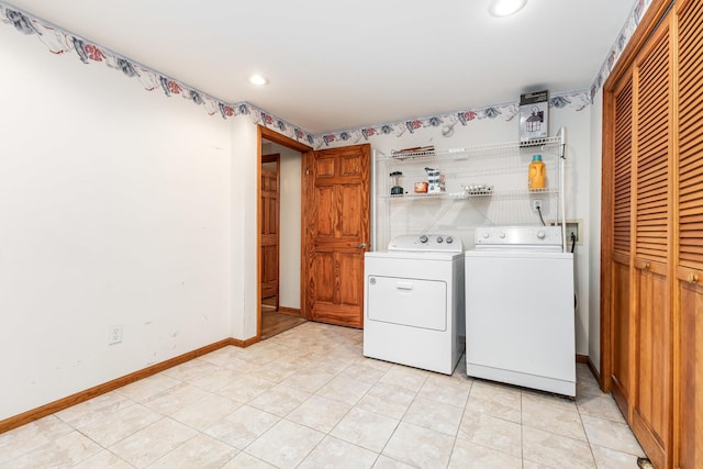 laundry room with light tile patterned floors and washer and clothes dryer