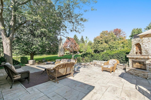 view of patio featuring an outdoor stone fireplace