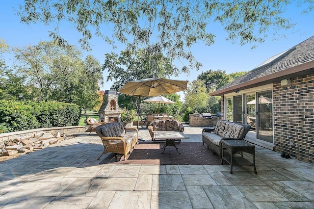 view of patio featuring an outdoor living space with a fireplace