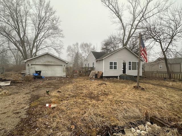 rear view of house with a garage and an outdoor structure