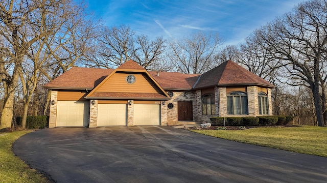 view of front of house with a garage and a front yard