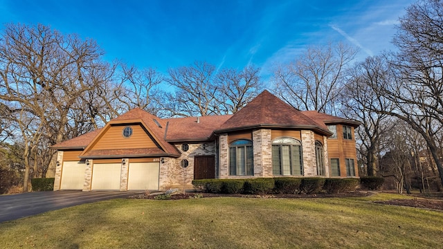 view of front of home featuring a garage and a front yard