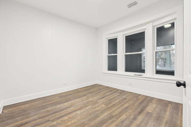 unfurnished room with dark hardwood / wood-style flooring