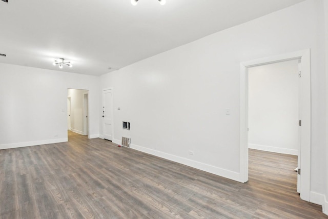 unfurnished room with dark hardwood / wood-style flooring