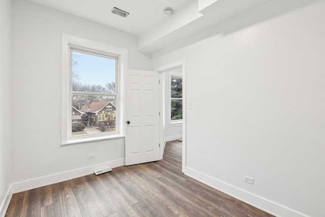 unfurnished room featuring dark hardwood / wood-style flooring