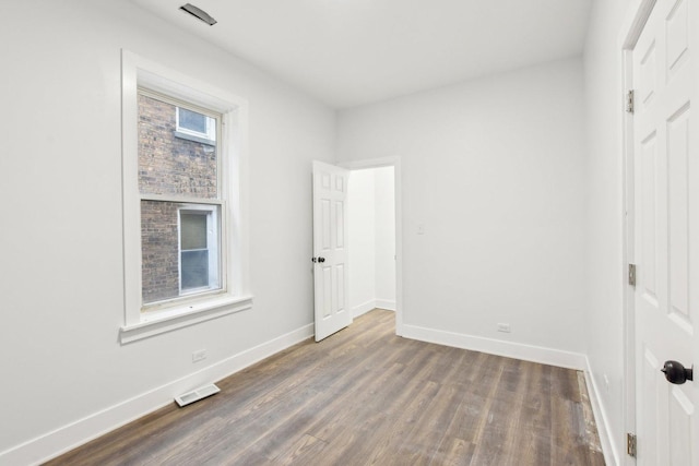 unfurnished bedroom featuring dark hardwood / wood-style floors