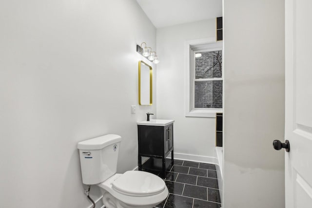 bathroom featuring vanity, tile patterned flooring, and toilet