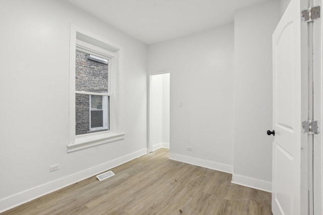 unfurnished room with light hardwood / wood-style flooring