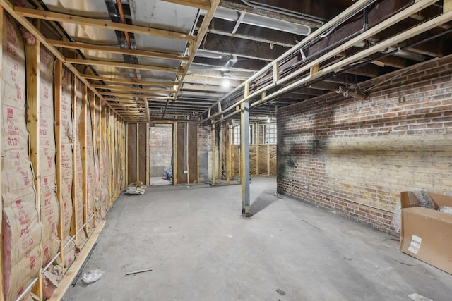 basement featuring brick wall