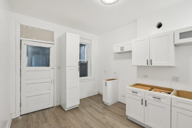 kitchen featuring white cabinets and light wood-type flooring