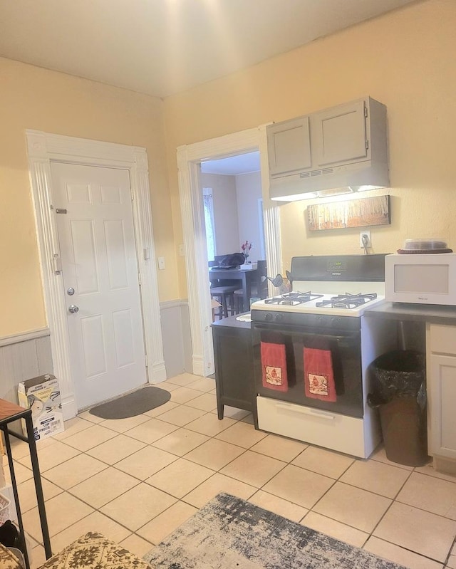 kitchen featuring light tile patterned floors and white appliances