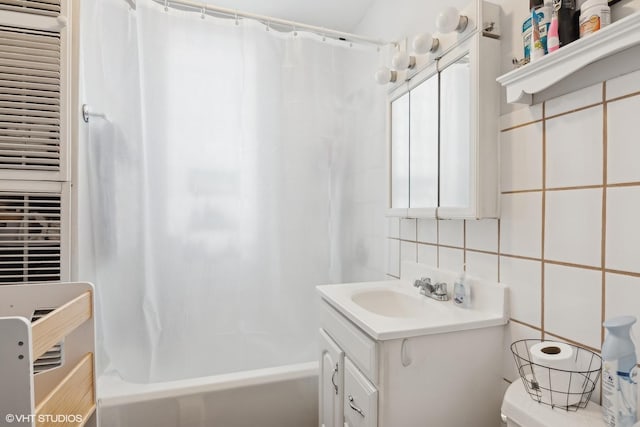 full bathroom featuring tasteful backsplash, tile walls, vanity, toilet, and shower / bath combo with shower curtain