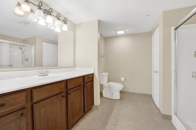 bathroom with vanity, tile patterned flooring, a shower with shower door, and toilet