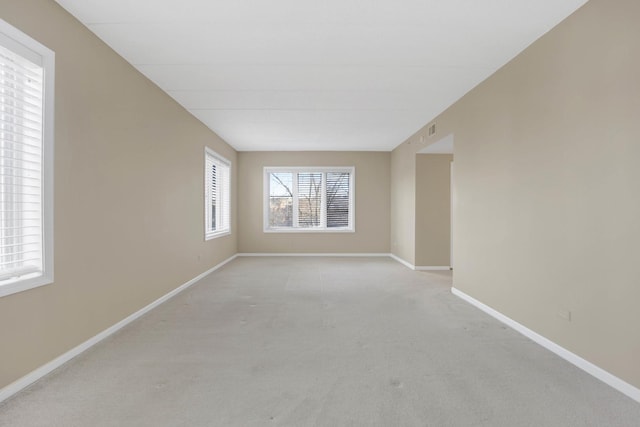 spare room featuring light colored carpet