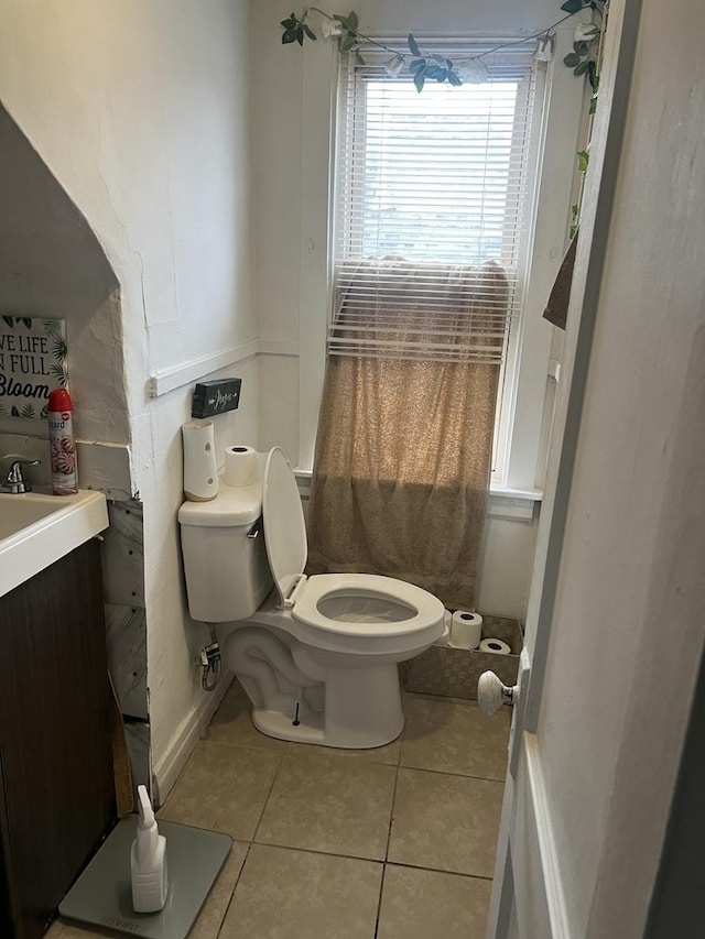 bathroom with vanity, toilet, and tile patterned flooring