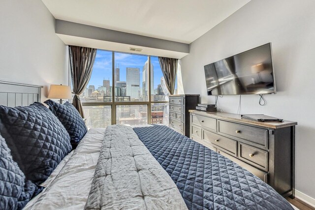 bedroom with hardwood / wood-style floors