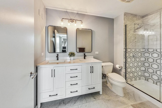 bathroom with vanity, tiled shower, and toilet