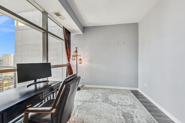 office area featuring hardwood / wood-style flooring and a wall of windows