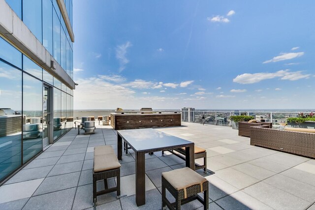 view of patio with a water view and an outdoor hangout area