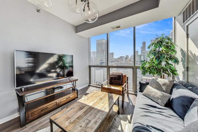 living room featuring hardwood / wood-style flooring and a wall of windows