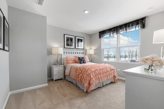 bedroom with light carpet, visible vents, and baseboards