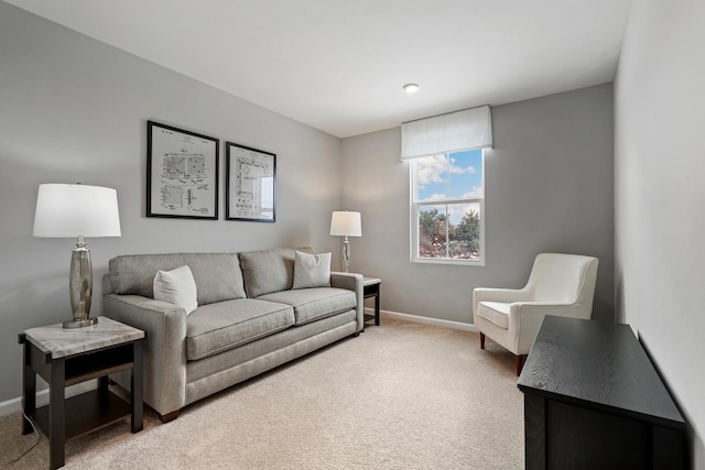 living room featuring light colored carpet and baseboards