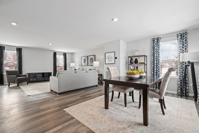 dining space with dark hardwood / wood-style floors and a healthy amount of sunlight