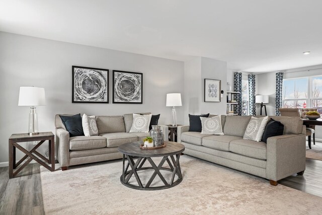 living area featuring wood finished floors and baseboards