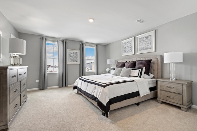 bedroom with light carpet, visible vents, and baseboards