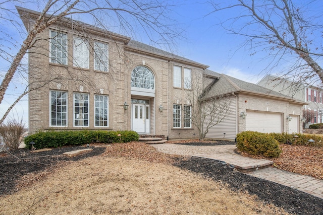 view of front of property featuring brick siding and an attached garage