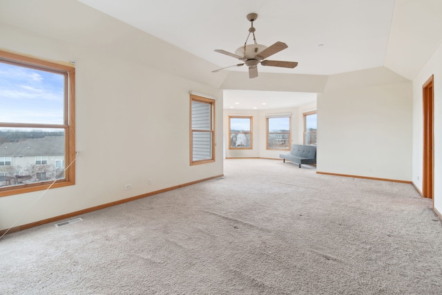 unfurnished room featuring a ceiling fan, baseboards, visible vents, carpet floors, and vaulted ceiling