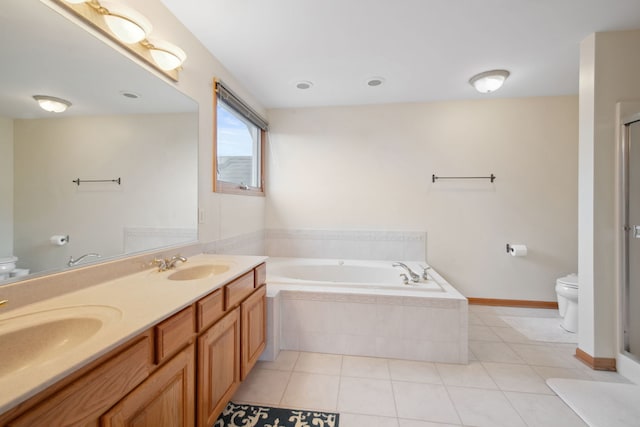 bathroom with a sink, toilet, and tile patterned floors