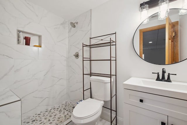 full bathroom with vanity, toilet, and a marble finish shower