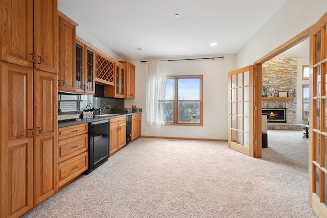 kitchen with wine cooler, french doors, dark countertops, light colored carpet, and brown cabinets