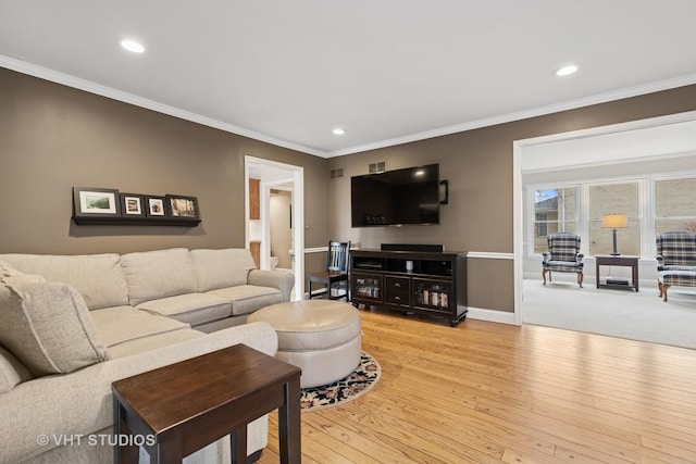 living area with crown molding, recessed lighting, and light wood-style floors