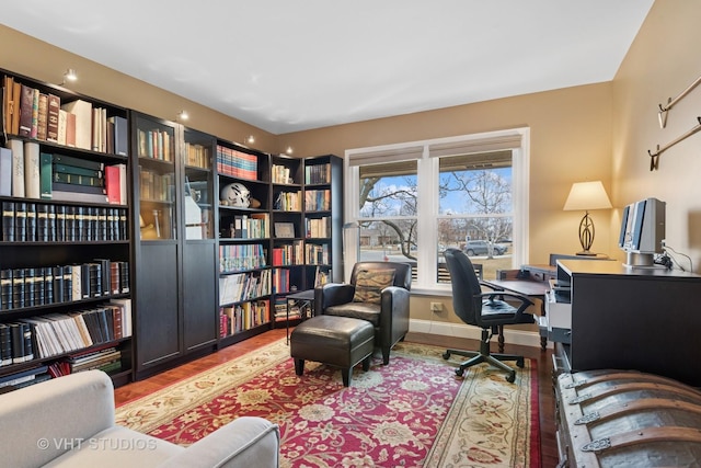 home office with baseboards and wood finished floors