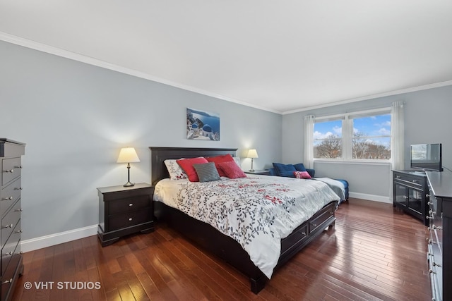 bedroom with dark wood-style floors, crown molding, and baseboards