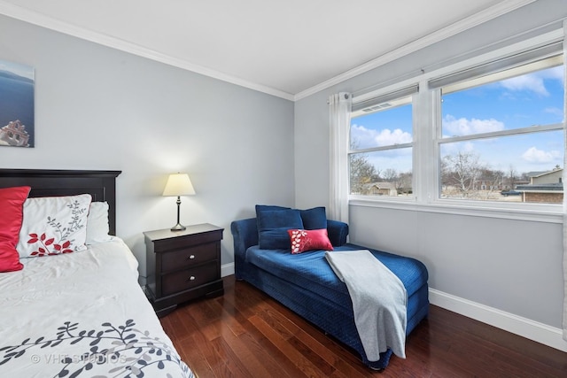 bedroom with crown molding, wood finished floors, and baseboards