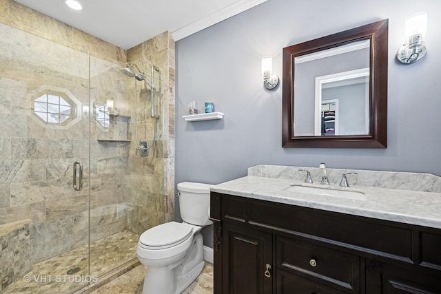 full bath with a shower stall, toilet, vanity, and baseboards