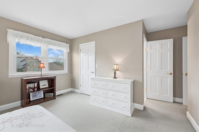 bedroom featuring light carpet, visible vents, and baseboards