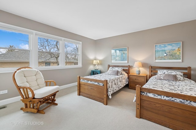 carpeted bedroom featuring visible vents and baseboards