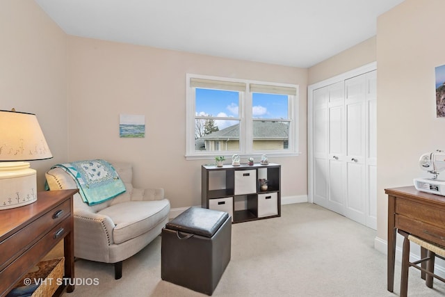 sitting room with light carpet and baseboards